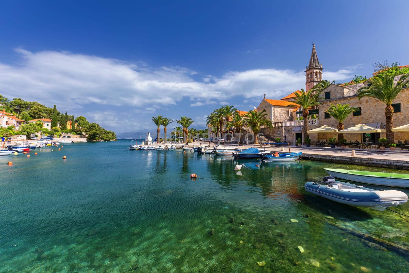 Fishing boats in Splitska village with beautiful port, Brac island, Croatia. Village of Splitska on Brac island seafront view, Dalmatia, Croatia, Croatia.