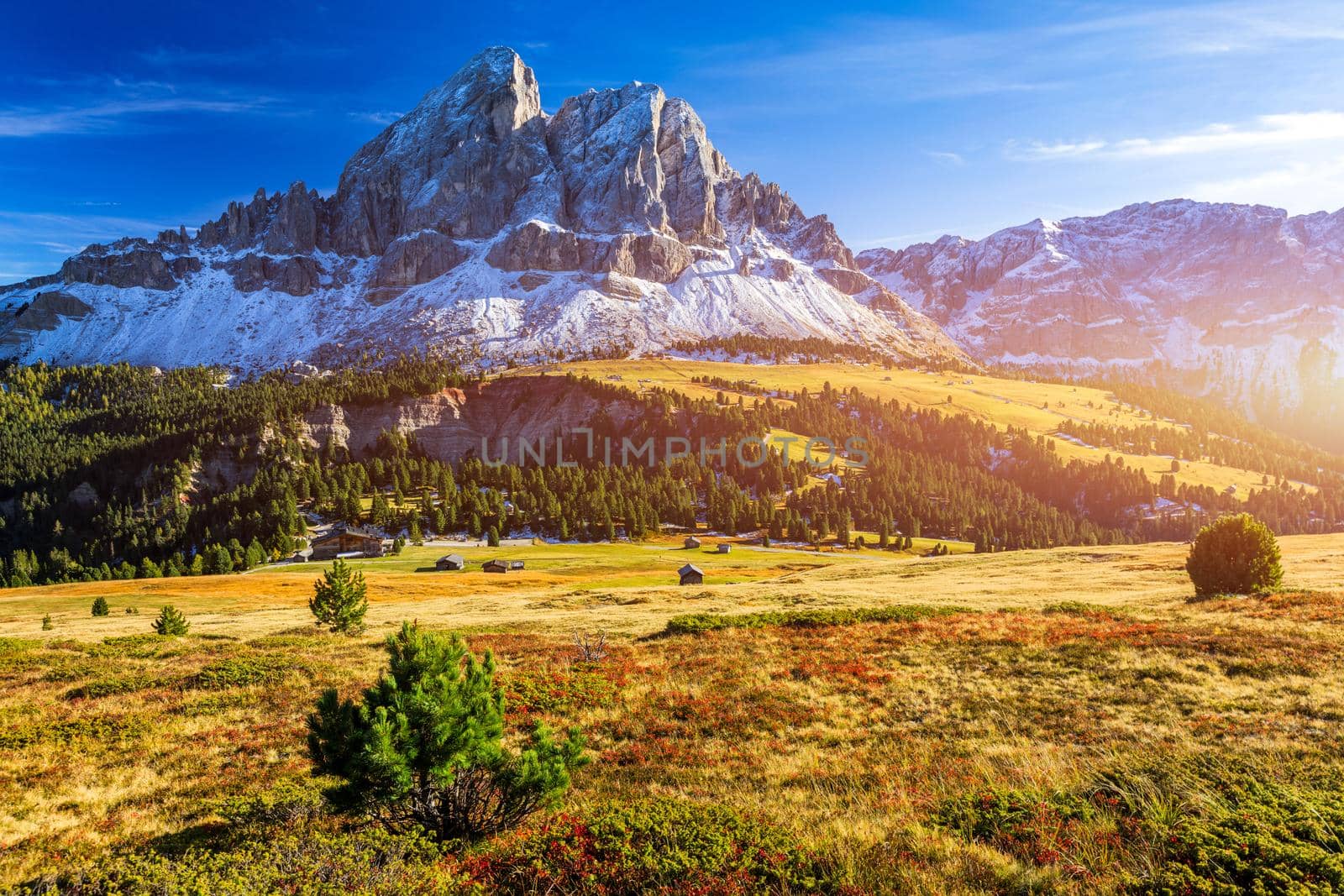 Stunning view of Peitlerkofel mountain from Passo delle Erbe in Dolomites, Italy. View of Sass de Putia (Peitlerkofel) at Passo delle Erbe, with wooden farm houses, Dolomites, South Tyrol, Italy.