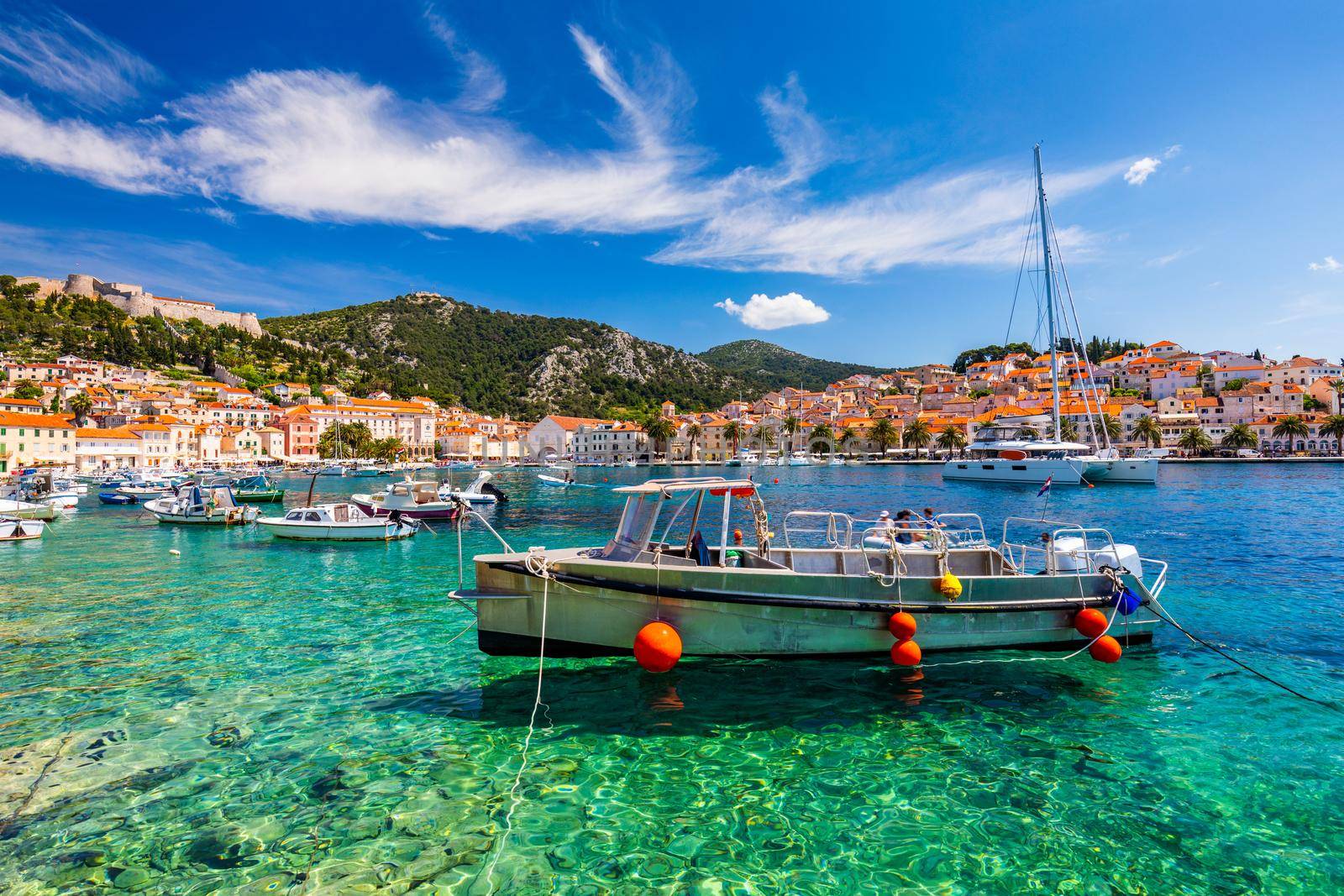 View at amazing archipelago with boats in front of town Hvar, Croatia. Harbor of old Adriatic island town Hvar. Popular touristic destination of Croatia. Amazing Hvar city on Hvar island, Croatia. 