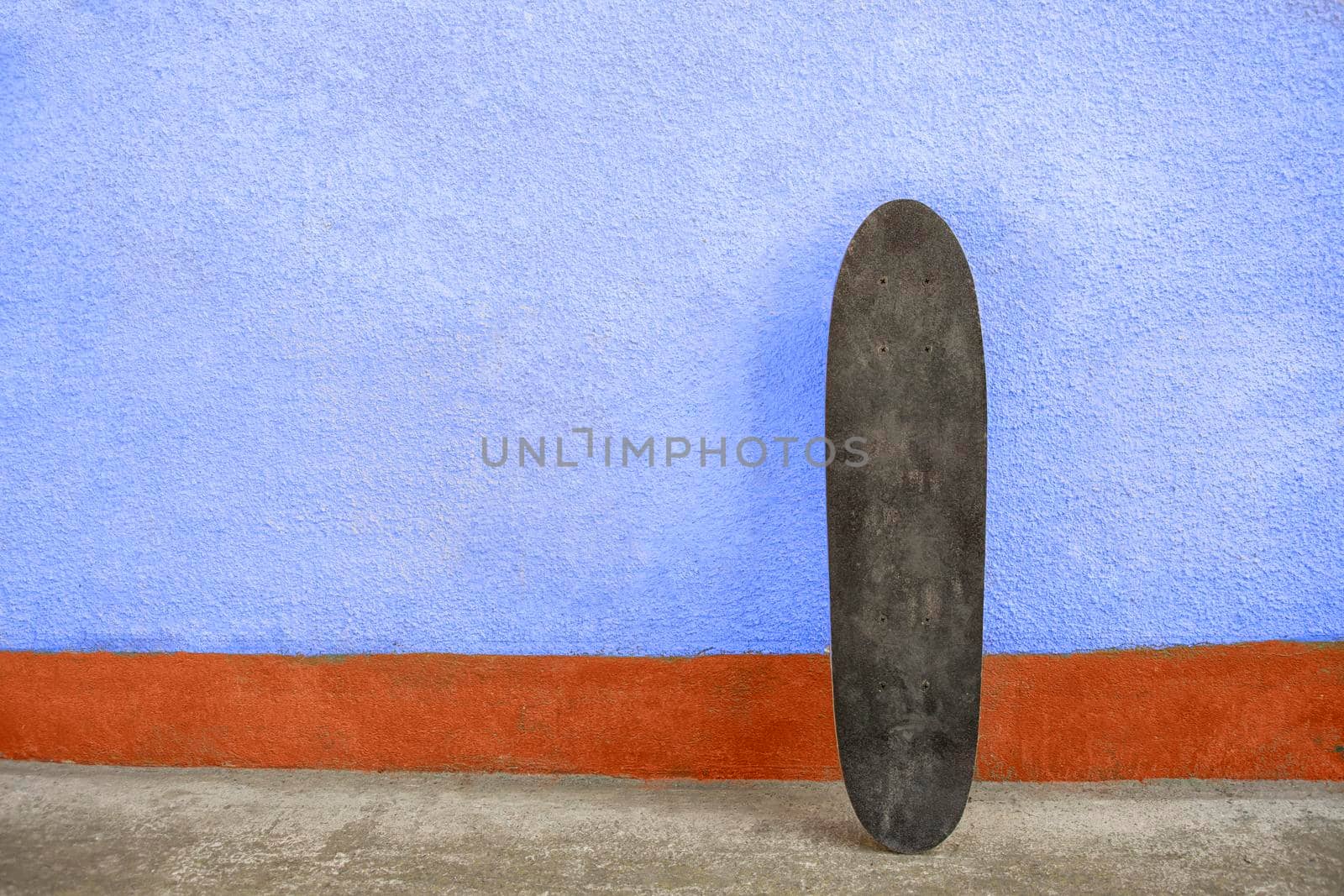 Skateboard on a wall. Used skateboard.