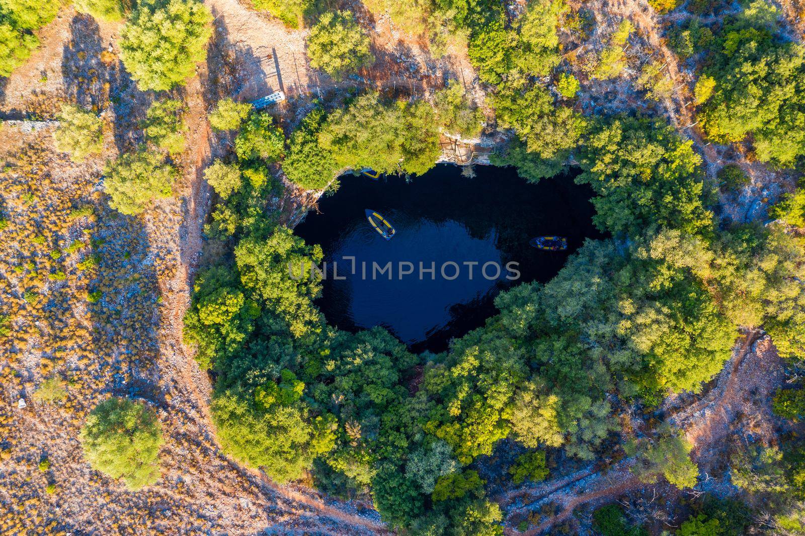 Famous Melissani lake on Kefalonia island, Karavomylos, Greece. On top of Melissani Cave (Melissani Lake) in Karavomylos village in Kefalonia island , Greece. Melissani Cave viewed from above.