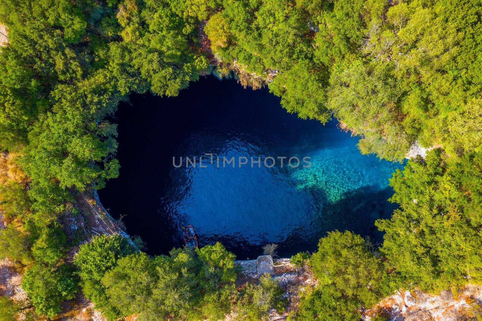 Famous Melissani lake on Kefalonia island, Karavomylos, Greece. On top of Melissani Cave (Melissani Lake) in Karavomylos village in Kefalonia island , Greece. Melissani Cave viewed from above.