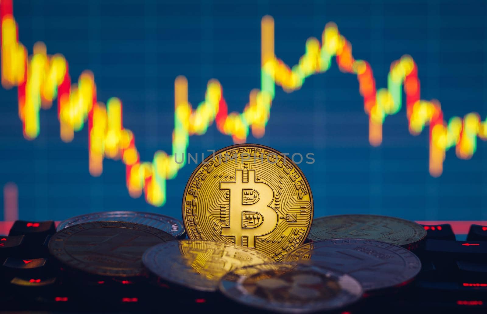 Bitcoin, litecoin and ripple coins currency finance money on graph chart background. Bitcoin as most important cryptocurrency concept. Stack of cryptocurrencies with a golden bitcoin in the middle.