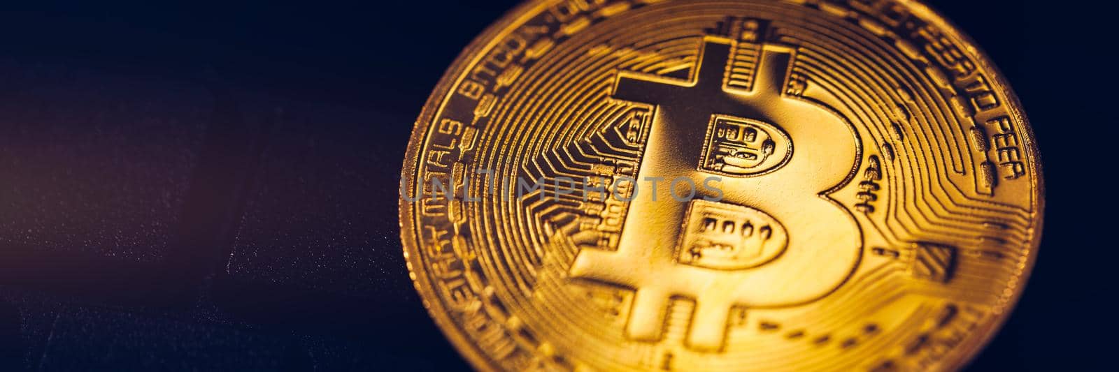 Bitcoin on compuer keyboard in background, symbol of electronic virtual money and mining cryptocurrency concept. Coin crypto currency bitcoin lies on the keyboard. Bitcoin on keyboard.