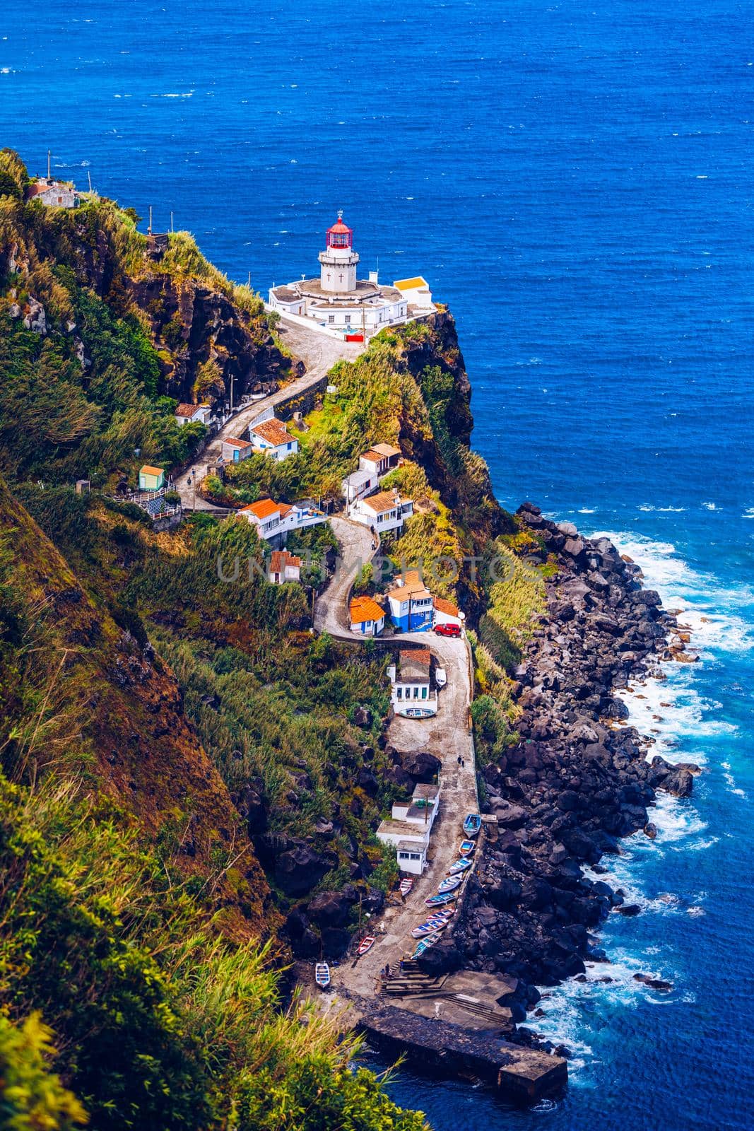 Dramatic view down to lighthouse on Ponta do Arnel, Nordeste, Sao Miguel Island, Azores, Portugal. Lighthouse Arnel near Nordeste on Sao Miguel Island, Azores, Portugal. 