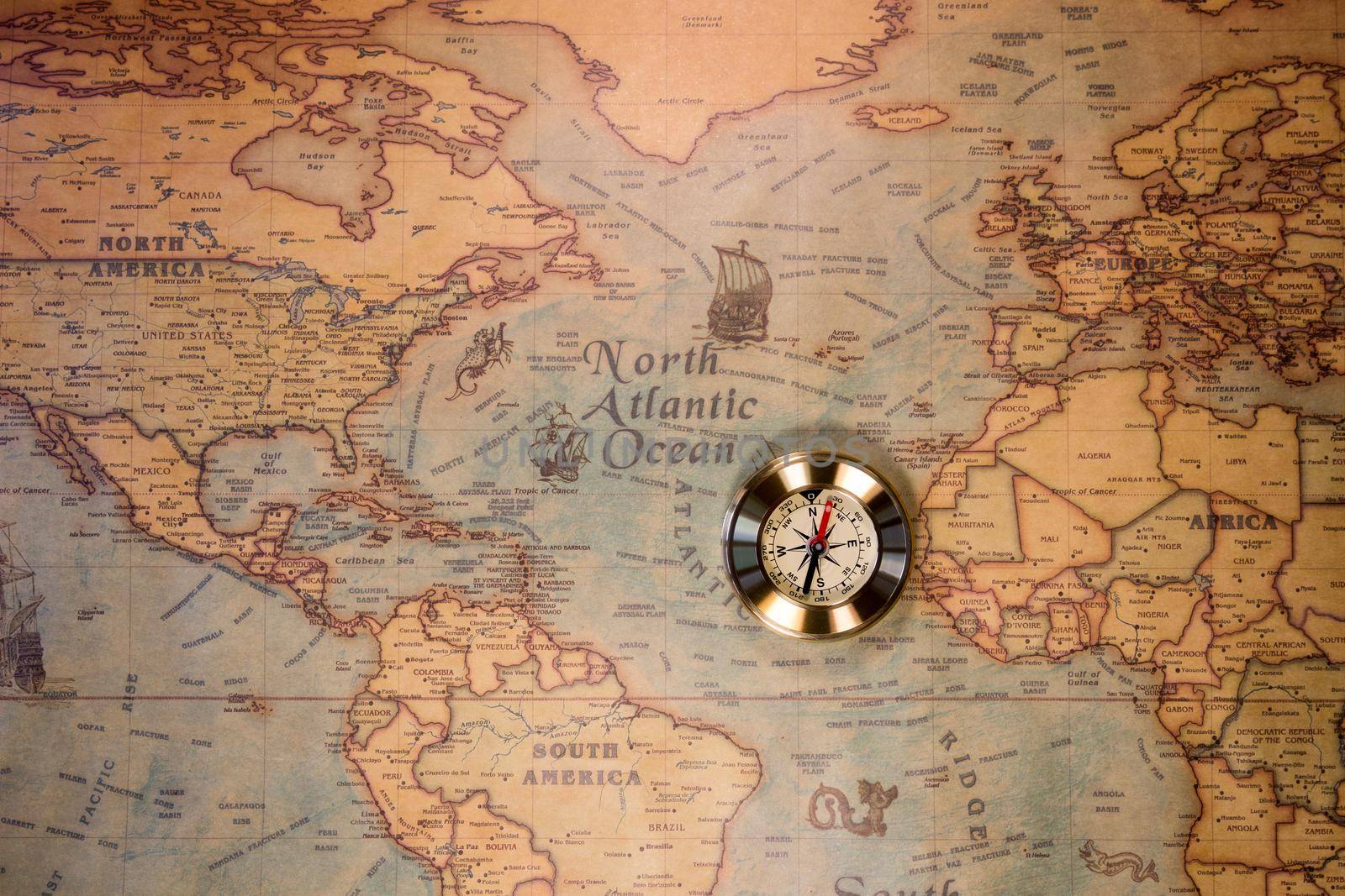Golden Compass and the Map. Travel and Navigation Theme. Map used for background is in Public domain. Map source: Library of Congress. Country: Belgium Year: 1570. Author: Abraham Ortelius (1527-1598)