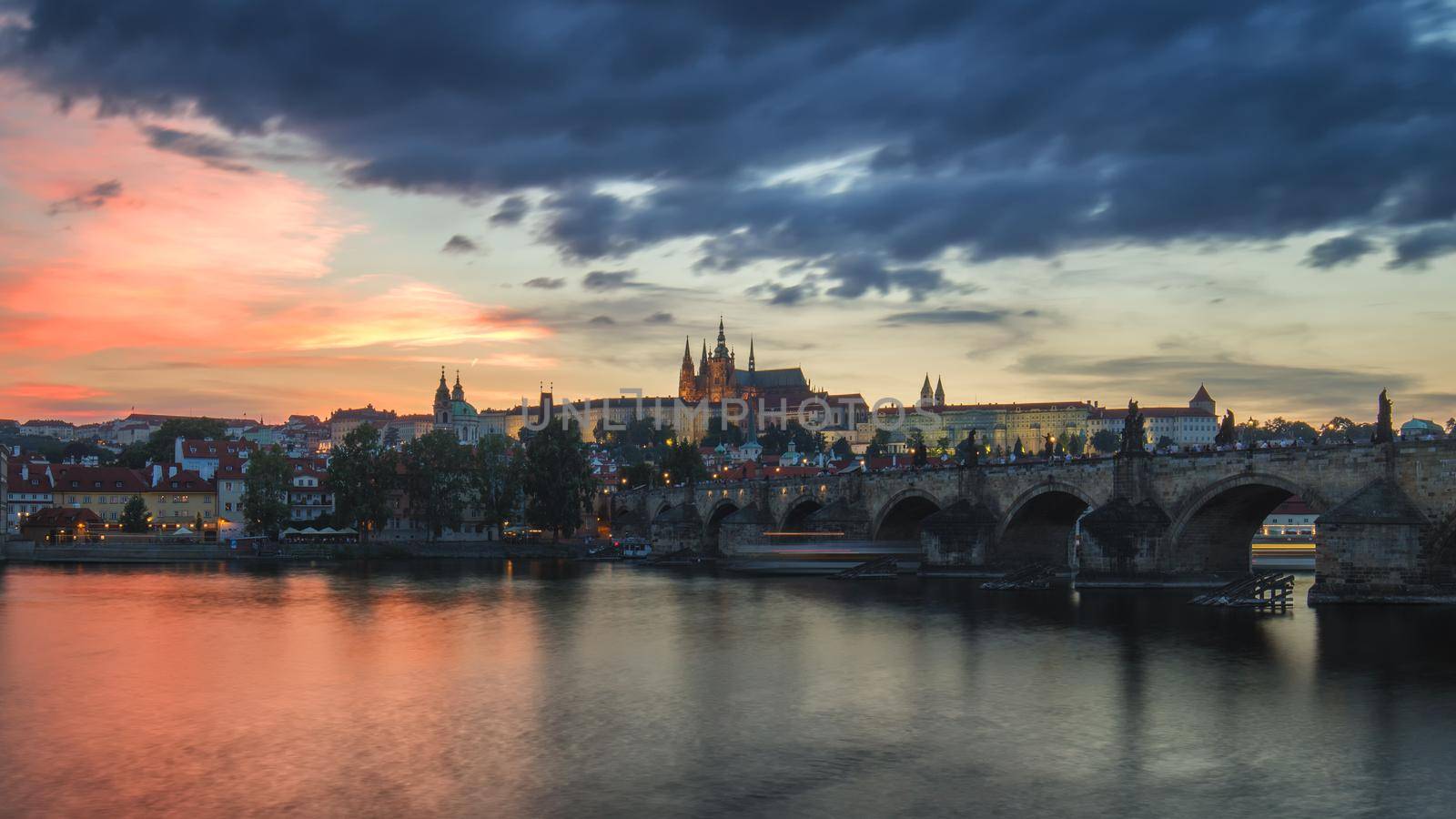 View of Prague Castle and Charles Bridge at sunset. Czechia