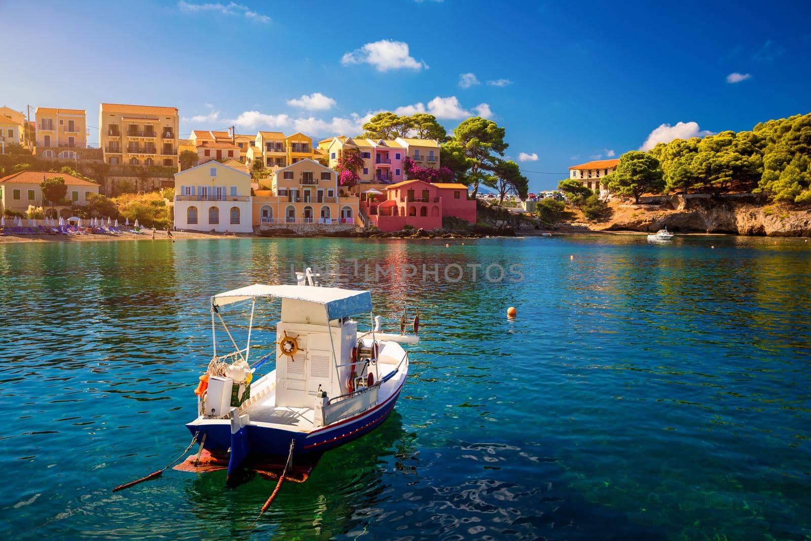 Turquoise colored bay in Mediterranean sea with beautiful colorful houses in Assos village in Kefalonia, Greece. Town of Assos with colorful houses on the mediterranean sea, Greece. 