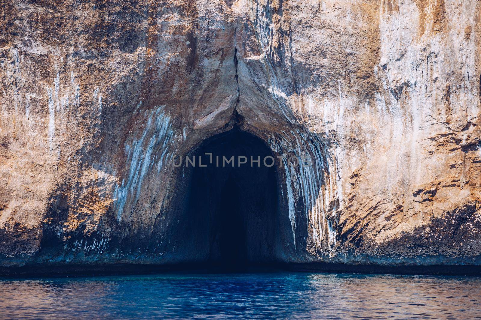 Blue sea and the characteristic caves of Cala Luna, a beach in the Golfo di Orosei, Sardinia, Italy. Big sea caves in the mediterranean coast. Sardinia, Italy.
