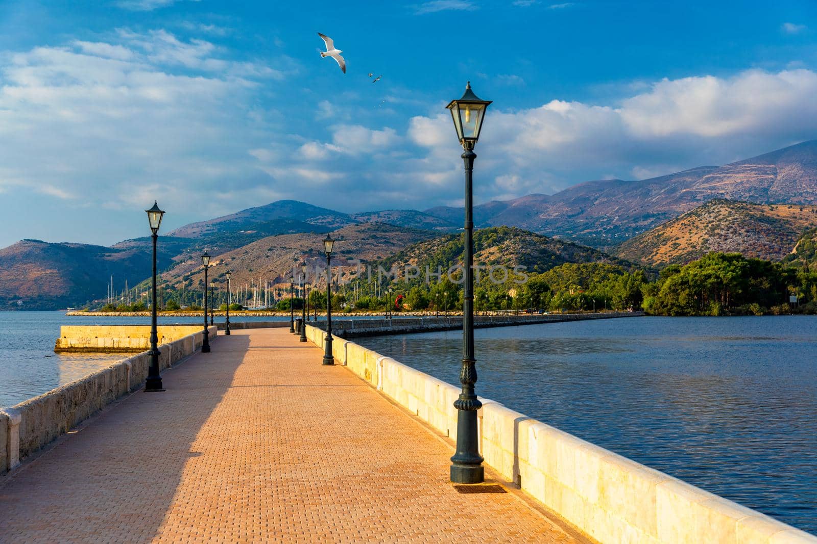 View of the De Bosset Bridge in Argostoli city on Kefalonia island. De Bosset Bridge on lakeside In Argostoli, Kefalonia. Obelisk and the de Bosset bridge in Argostoli, Kefalonia, Greece