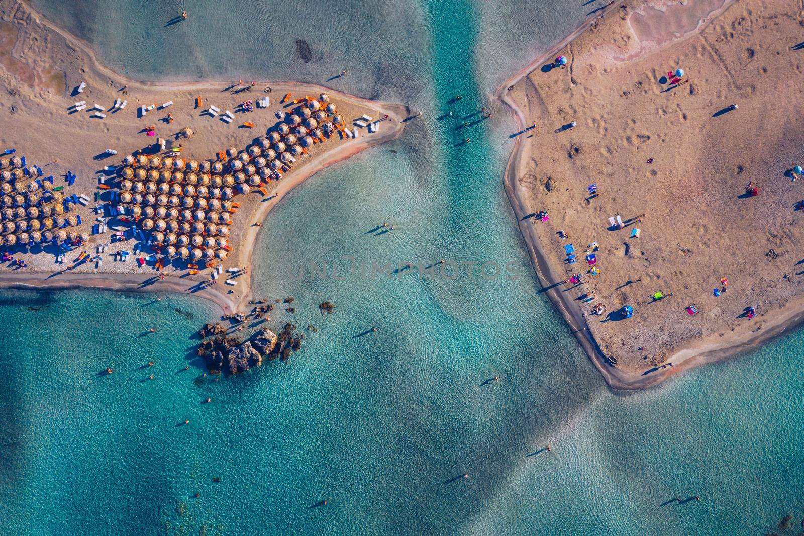 Aerial view of beautiful tropical Elafonissi Beach with pink sand. View of a nice tropical Elafonissi beach from the air. Beautiful sky, sea, resort. Elafonissi beach, Crete, Greece.