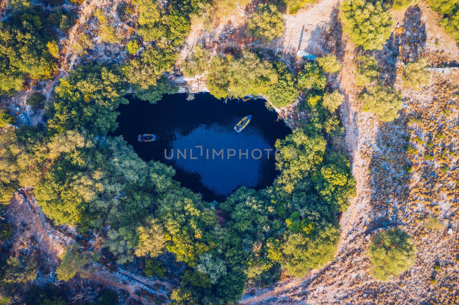 Famous Melissani lake on Kefalonia island, Karavomylos, Greece. On top of Melissani Cave (Melissani Lake) in Karavomylos village in Kefalonia island , Greece. Melissani Cave viewed from above.