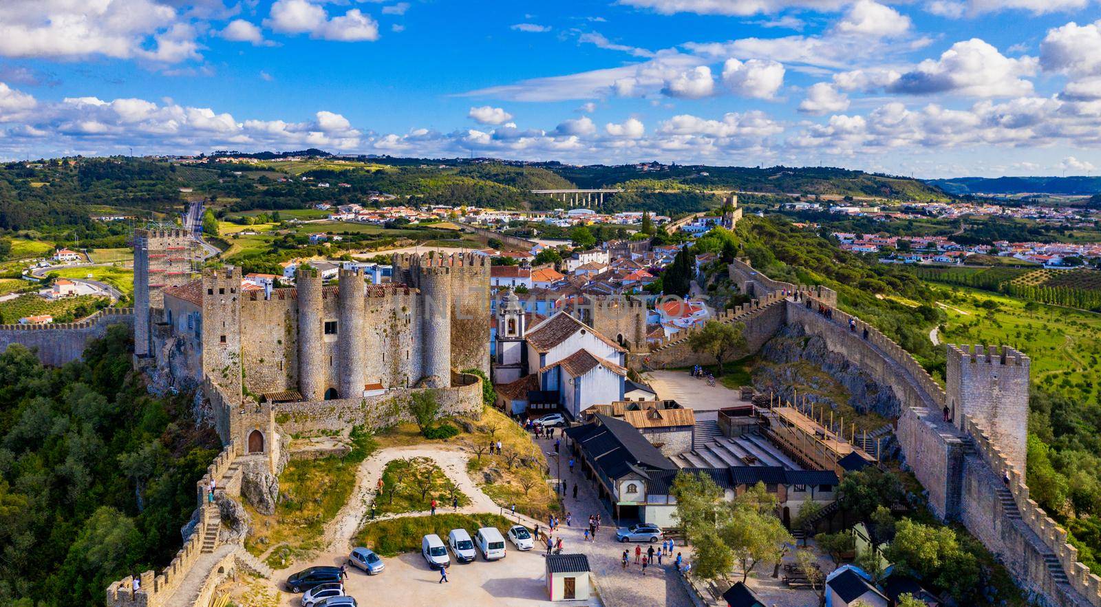 Aerial view of the historic walled town of Obidos at sunset, near Lisbon, Portugal. Aerial shot of Obidos Medieval Town, Portugal. Aerial view of medieval fortress in Obidos. Portugal.