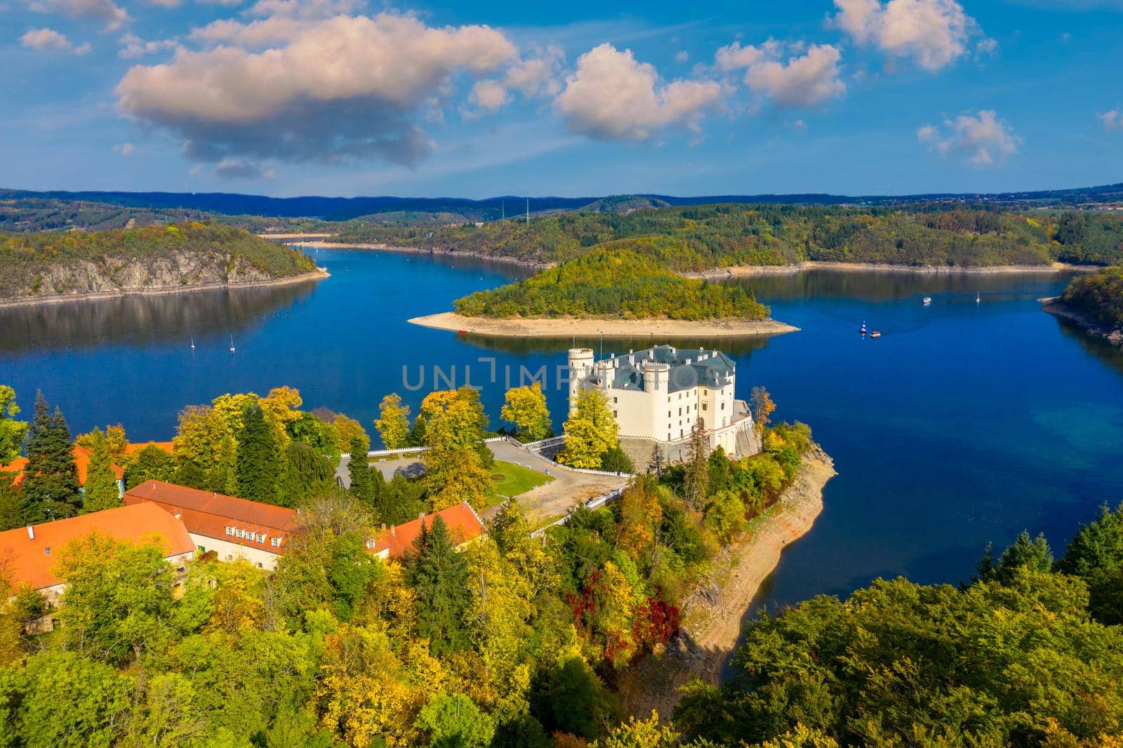 Aerial view chateau Orlik, above Orlik reservoir in beautiful autumn nature. Romantic royal Schwarzenberg castle above water level. Czechia. Orlik castle across the River Vltava, Czech Republic.