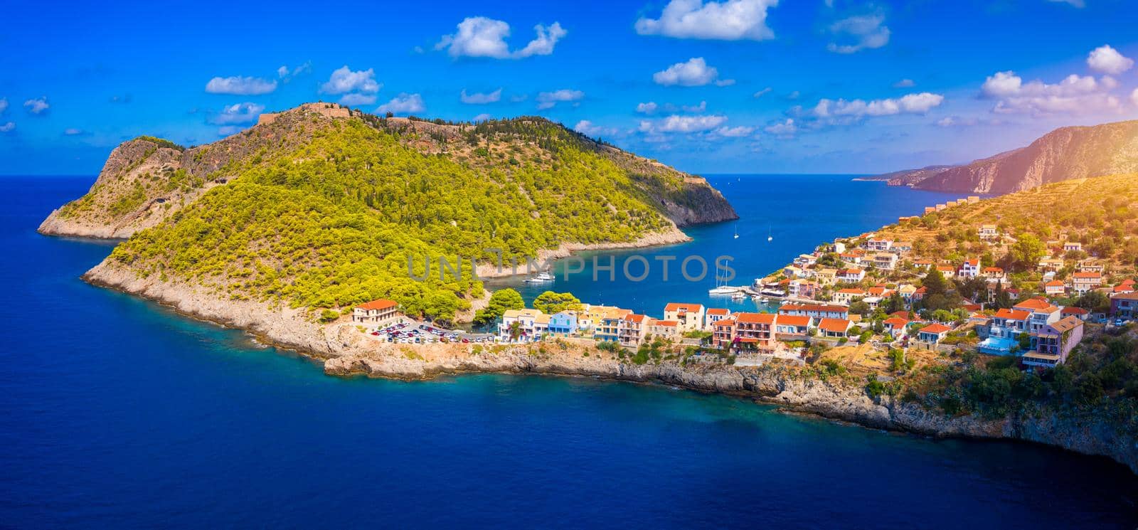 Aerial drone view video of beautiful and picturesque colorful traditional fishing village of Assos in island of Cefalonia, Ionian, Greece. Peninsula of Assos in Cephalonia (Kefalonia), Greece