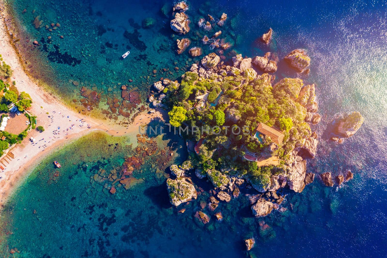 Aerial view of Isola Bella in Taormina, Sicily, Italy. Isola Bella is small island near Taormina, Sicily, Italy. Narrow path connects island to mainland Taormina beach in azure waters of Ionian Sea. 