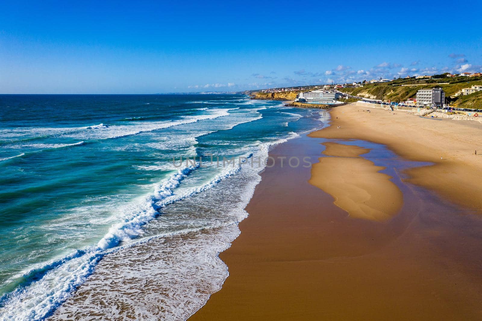 Praia Grande, Portugal. Beautiful sunset in the portuguese beach Praia Grande, in Portugal. Beach of Praia Grande. View of Atlantic beach and big waves. Colares, Sintra, Portugal. 