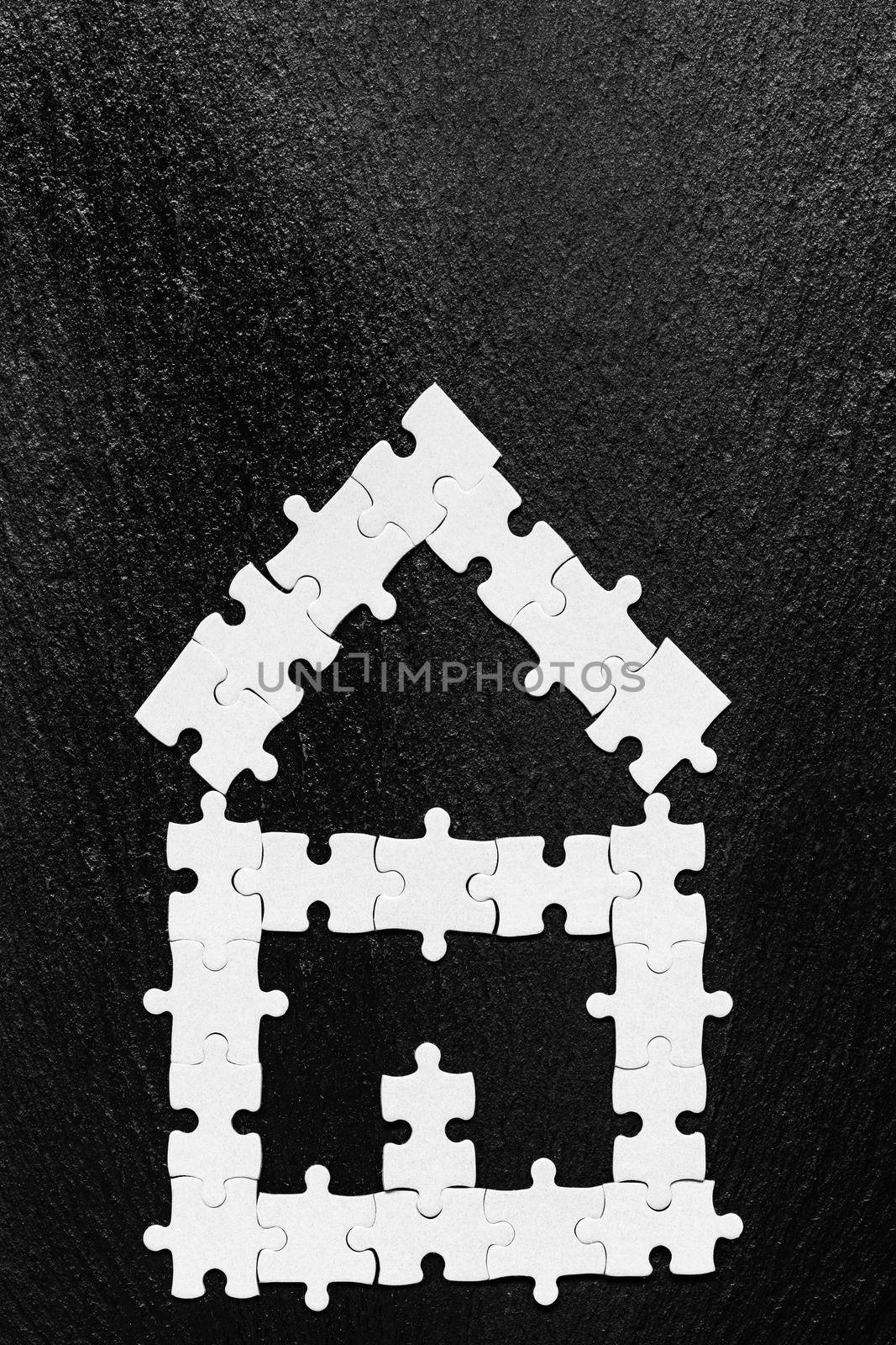 House made of puzzles. Modern house puzzle white pieces for concept design. Jigsaw Home, building, exterior. Puzzle construction renting, leasing, mortgage. House is made up of pieces of puzzles.