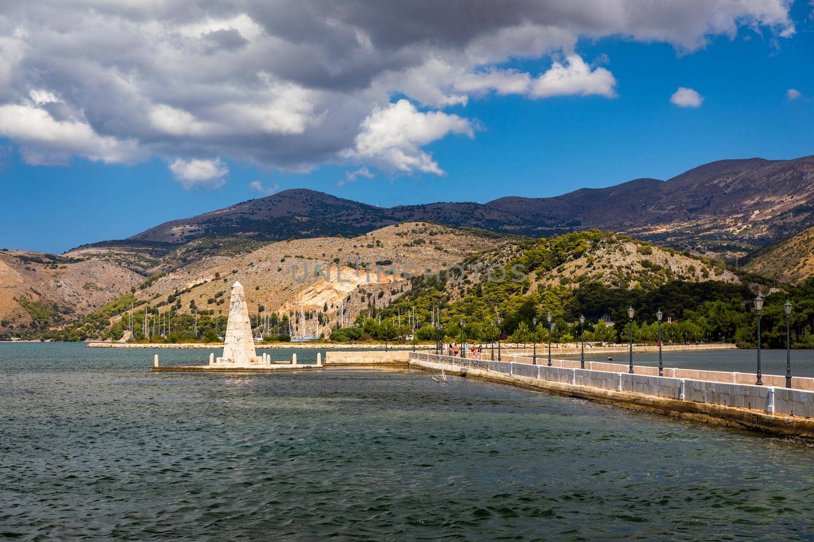 View of the De Bosset Bridge in Argostoli city on Kefalonia island. De Bosset Bridge on lakeside In Argostoli, Kefalonia. Obelisk and the de Bosset bridge in Argostoli, Kefalonia, Greece