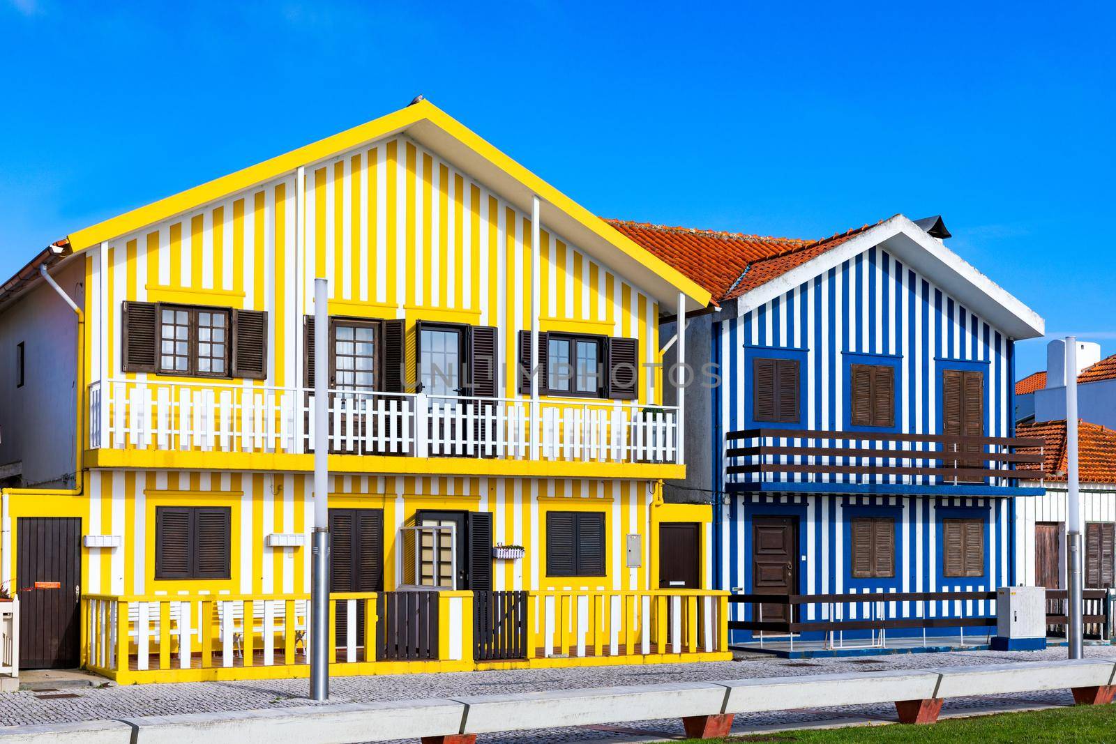 Street with colorful houses in Costa Nova, Aveiro, Portugal. Street with striped houses, Costa Nova, Aveiro, Portugal. Facades of colorful houses in Costa Nova, Aveiro, Portugal.