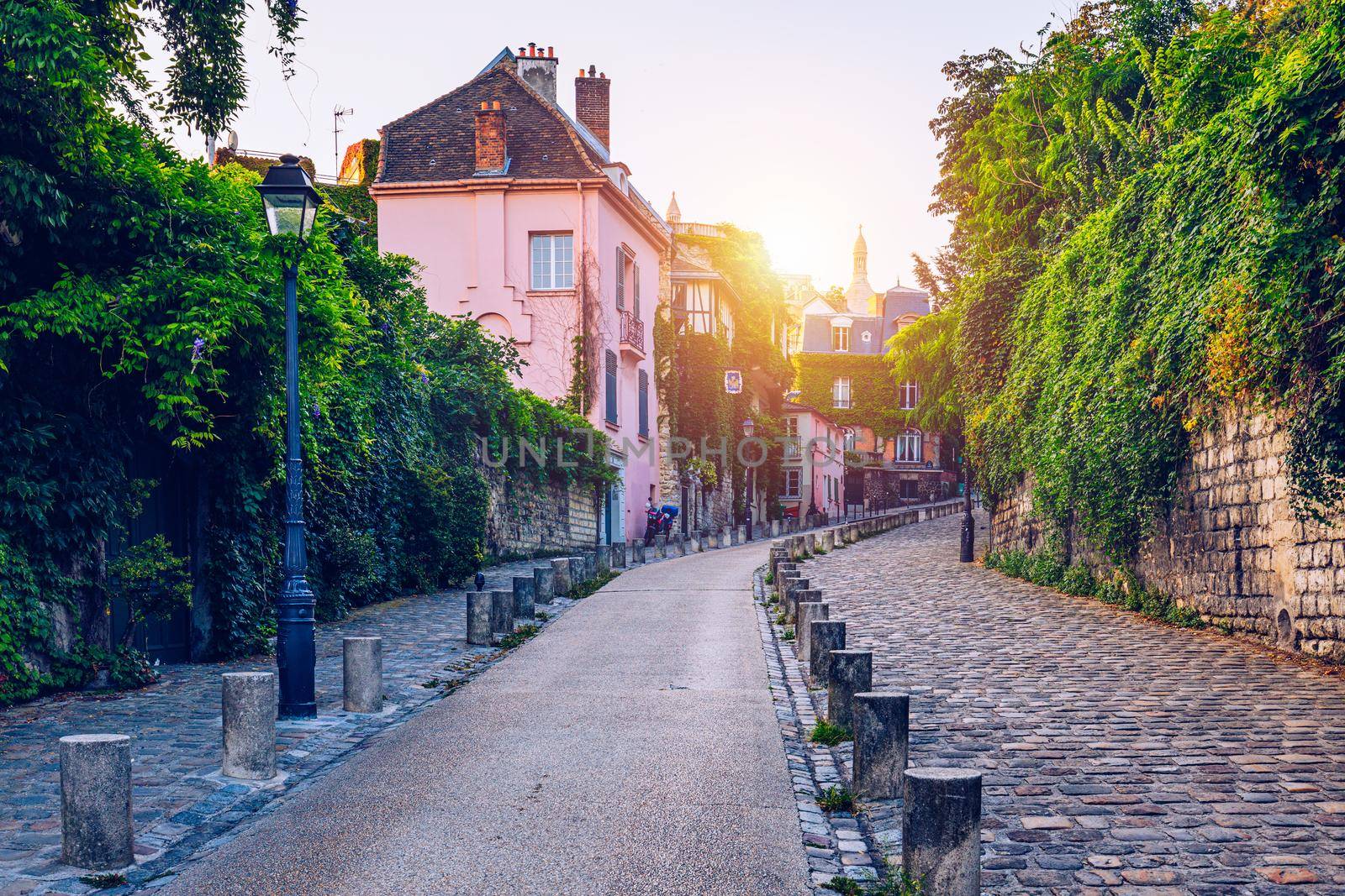 Montmartre district of Paris. Houses on narrow road in Montmartre district of Paris. View of cozy street in quarter Montmartre in Paris, France. Architecture and landmarks of Paris. Postcard of Paris.