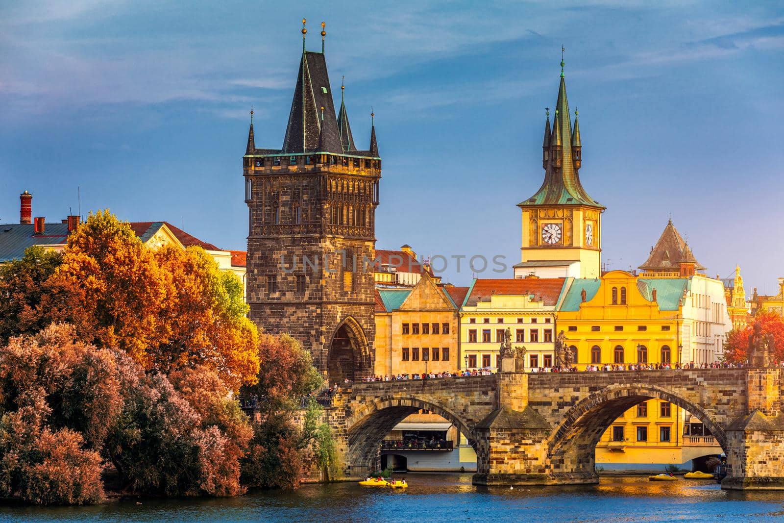 Autumn view to Charles bridge on Vltava river in Prague, Czech Republic. Autumn view to Charles Bridge, Prague old town and Vltava river. Czechia. Scenic autumn view of the Old Town with red foliage.