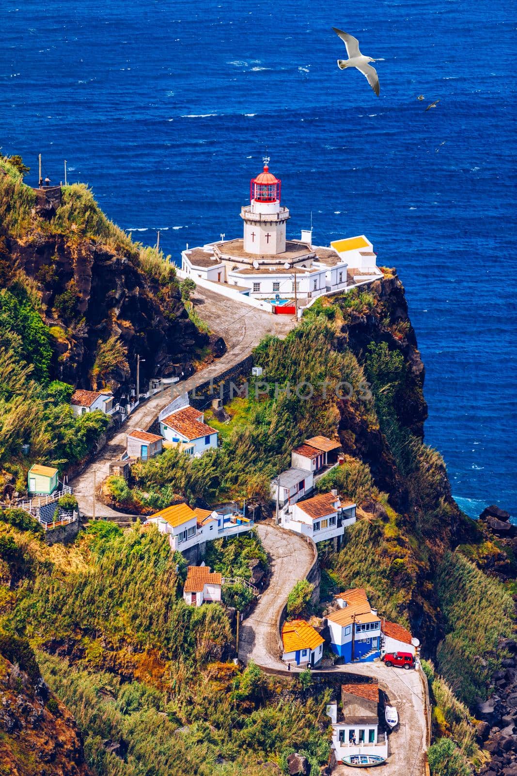 Dramatic view down to lighthouse on Ponta do Arnel, Nordeste, Sao Miguel Island, Azores, Portugal. Lighthouse Arnel near Nordeste on Sao Miguel Island, Azores, Portugal. 