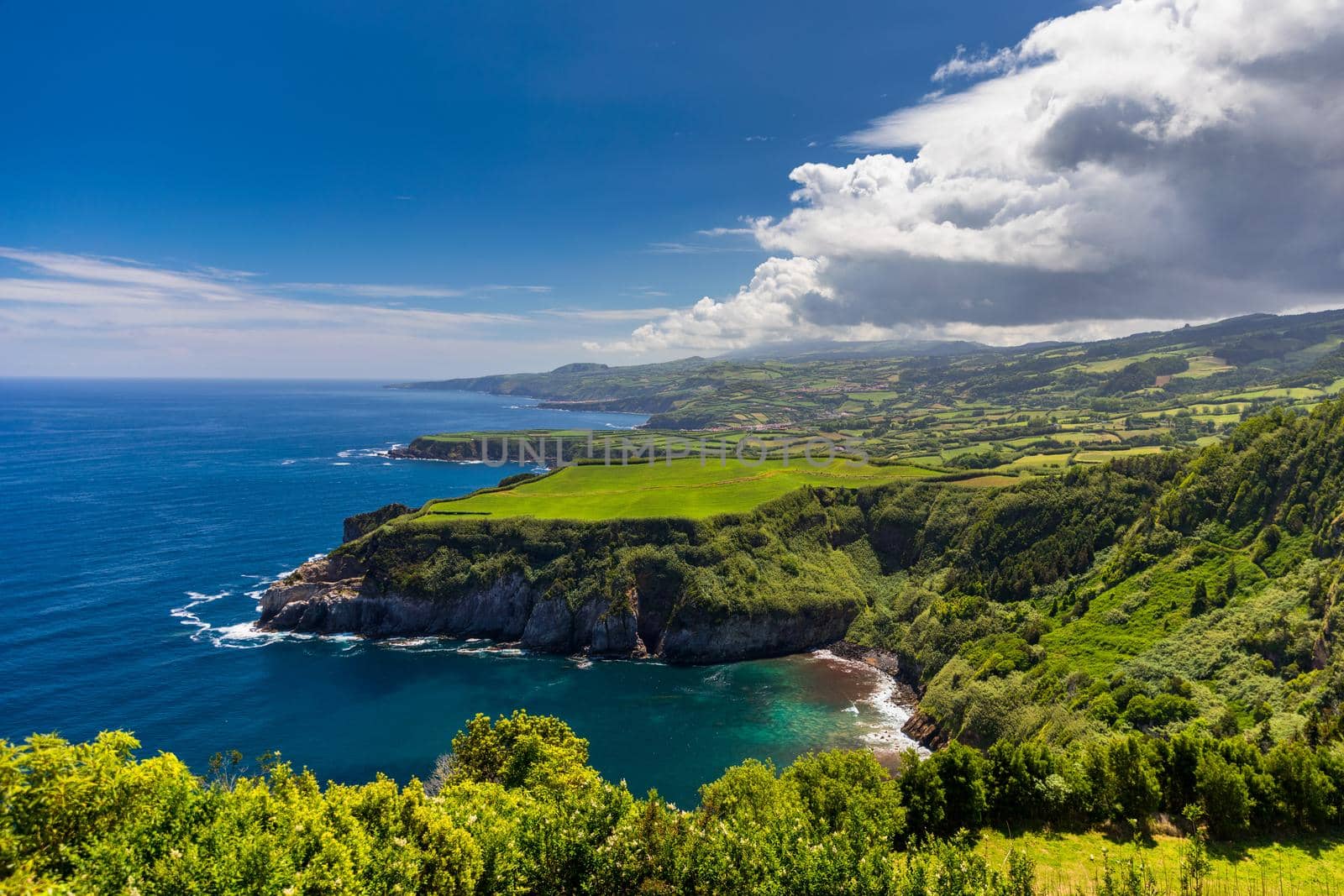 Azores panoramic view of natural landscape, wonderful scenic island of Portugal. Beautiful lagoons in volcanic craters and green fields. Tourist attraction and travel destination. Azores, Portugal.