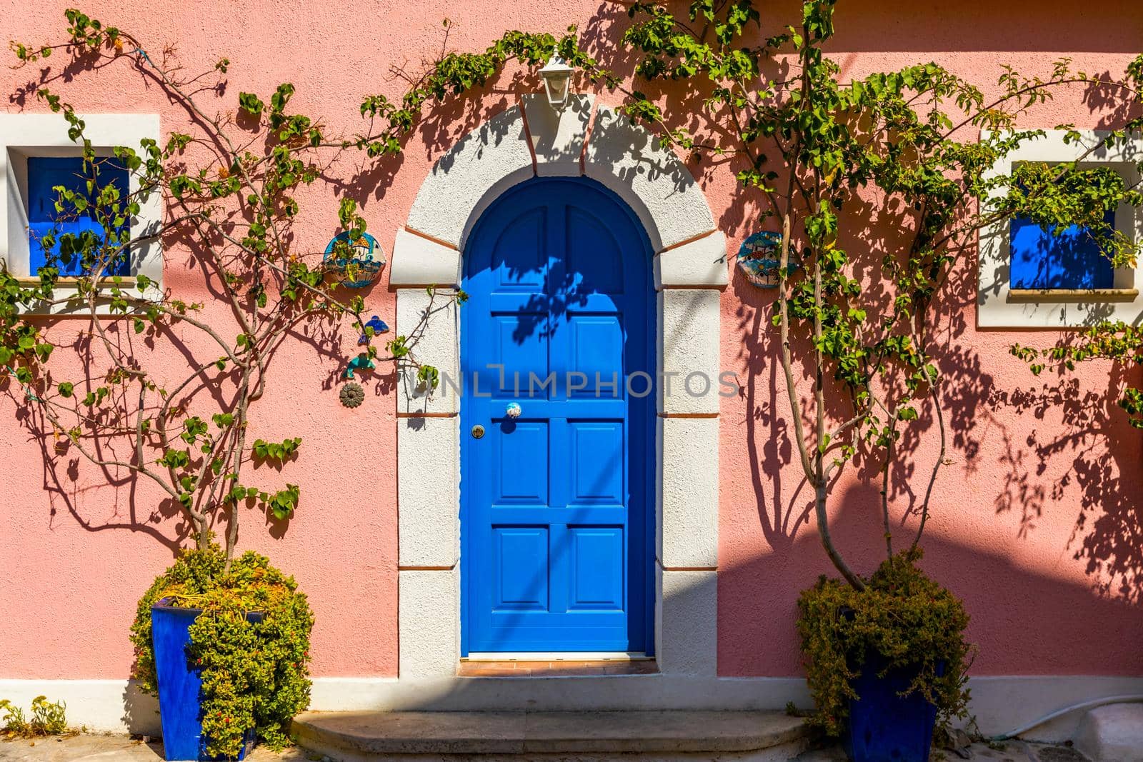 Assos village in Kefalonia, Greece. Turquoise colored bay in Mediterranean sea with beautiful colorful houses in Assos village in Kefalonia, Greece, Ionian island, Cephalonia, Assos village.