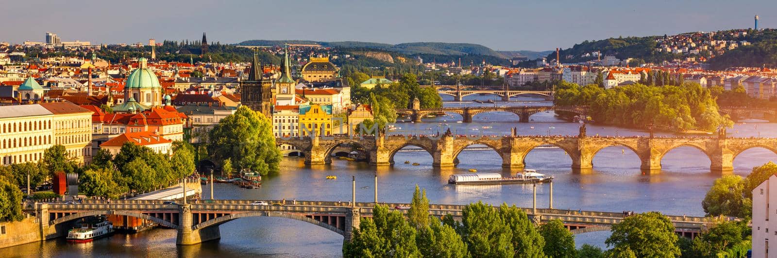 Scenic view of the Old Town pier architecture and Charles Bridge over Vltava river in Prague, Czech Republic. Prague iconic Charles Bridge (Karluv Most) and Old Town Bridge Tower at sunset, Czechia.