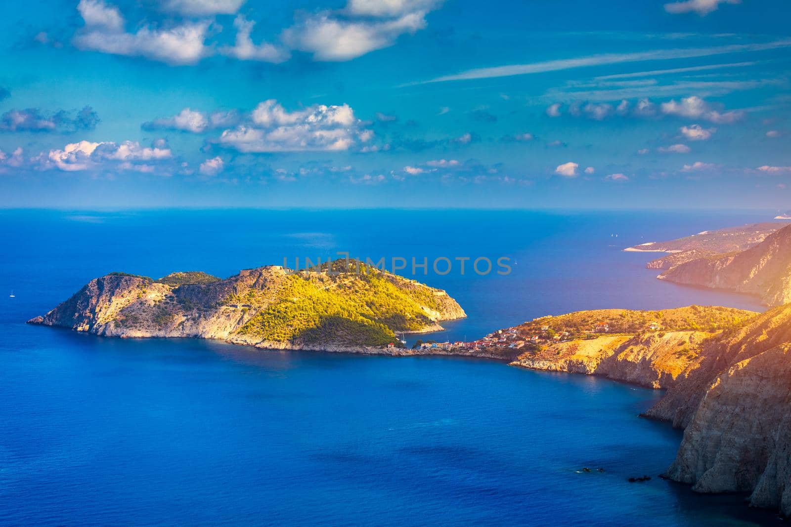 Assos village in Kefalonia, Greece. Turquoise colored bay in Mediterranean sea with beautiful colorful houses in Assos village in Kefalonia, Greece, Ionian island, Cephalonia, Assos village.