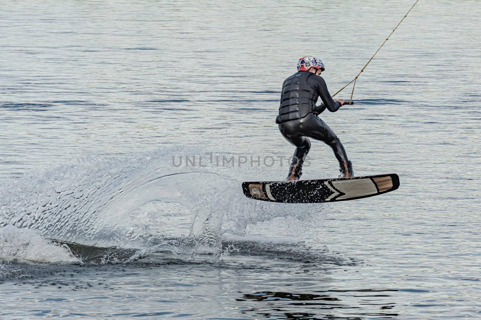 Spain, Tenerife Island - May 27, 2021: Sports. The kitesurfer sat down on the board. Stock photography.