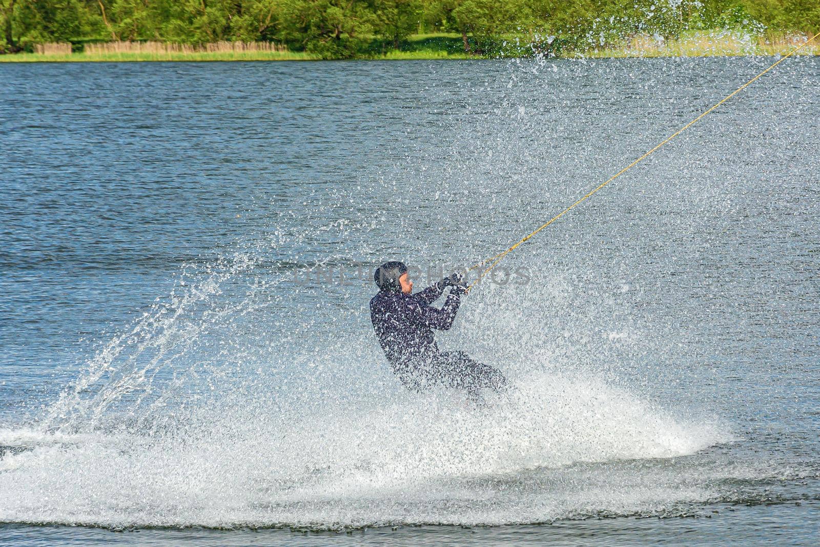 Belarus, Minsk - May 23, 2021: Sports. The kitesurfer splashed down on the surface of the water with large splashes. Stock photography.