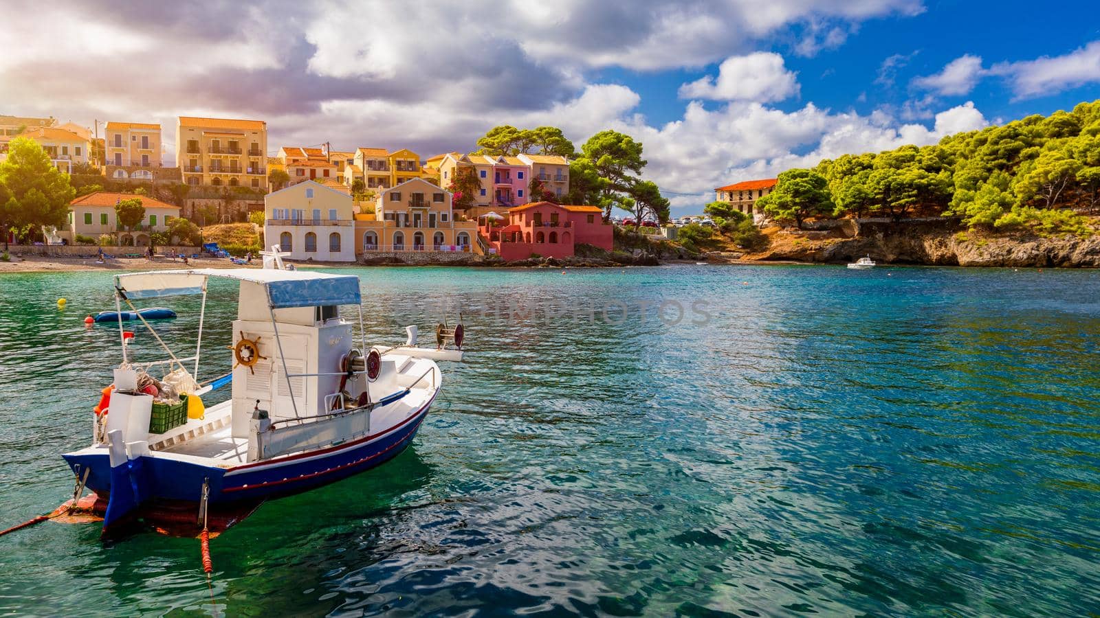 Assos village in Kefalonia, Greece. Turquoise colored bay in Mediterranean sea with beautiful colorful houses in Assos village in Kefalonia, Greece, Ionian island, Cephalonia, Assos village.