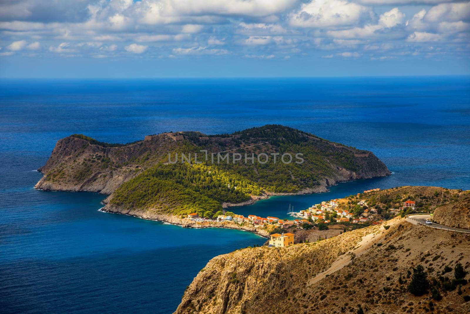 Assos village in Kefalonia, Greece. Turquoise colored bay in Mediterranean sea with beautiful colorful houses in Assos village in Kefalonia, Greece, Ionian island, Cephalonia, Assos village.