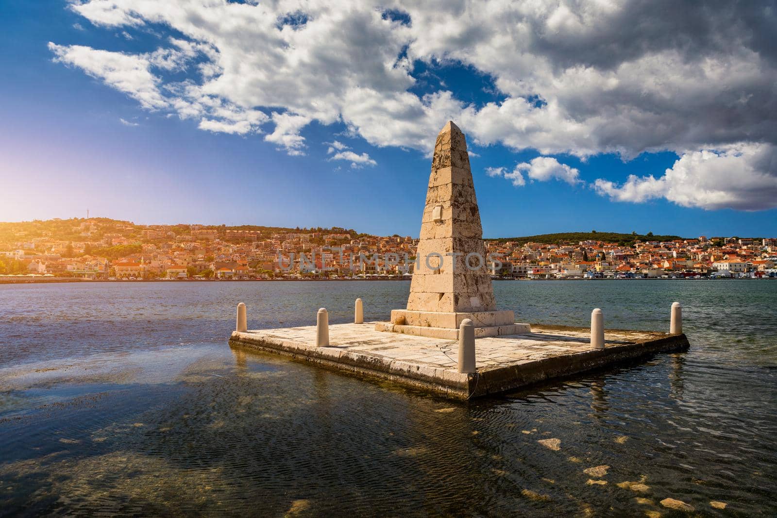 View of the De Bosset Bridge in Argostoli city on Kefalonia island. De Bosset Bridge on lakeside In Argostoli, Kefalonia. Obelisk and the de Bosset bridge in Argostoli, Kefalonia, Greece