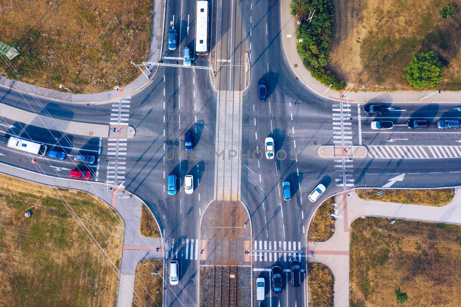 Aerial top view of crossroads with lot of vehicles or car traffic, modern urban intersections and junctions in midtown. Road traffic on crossroad or intersection downtown of European. 
