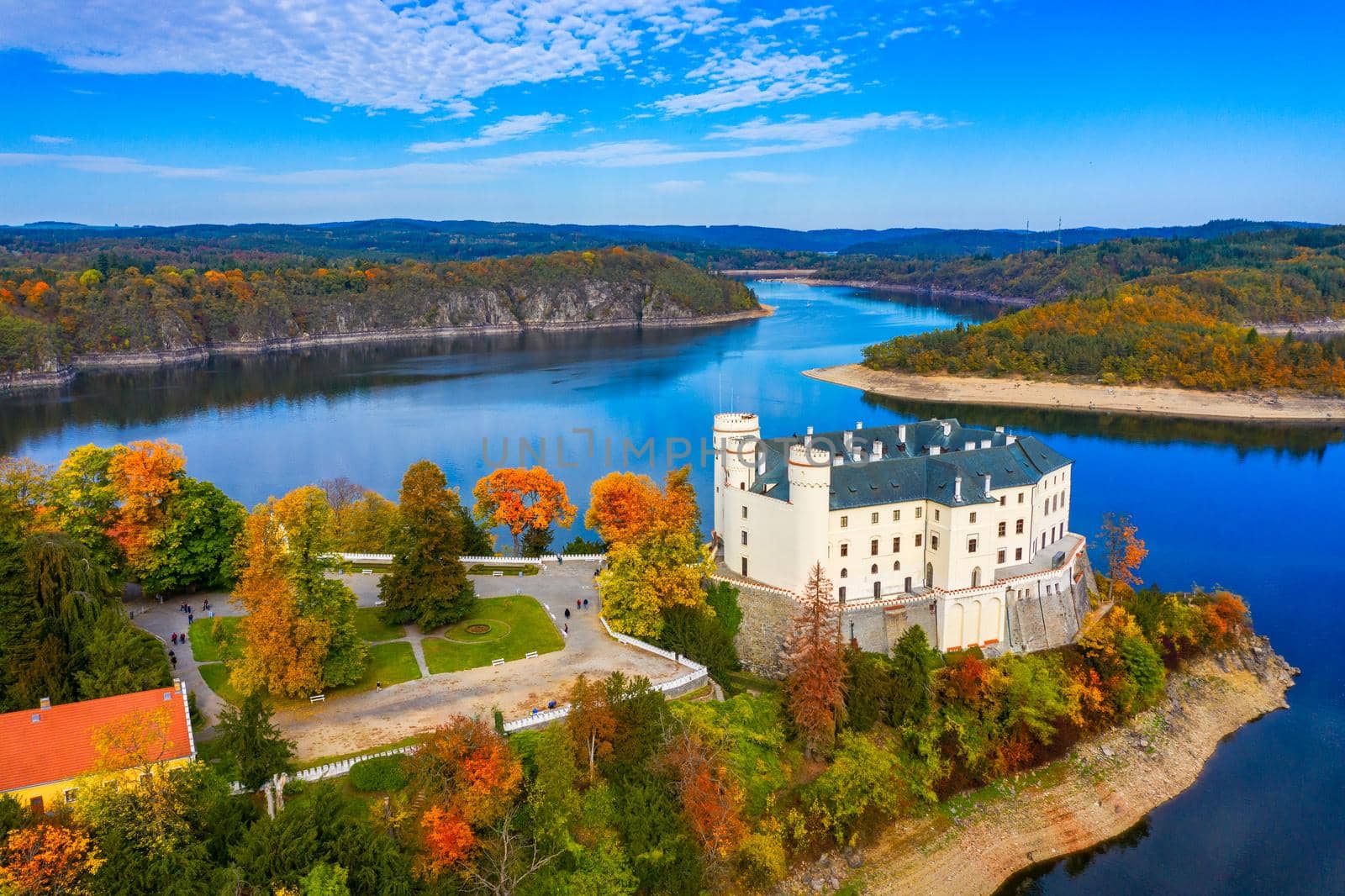 Aerial view chateau Orlik, above Orlik reservoir in beautiful autumn nature. Romantic royal Schwarzenberg castle above water level. Czechia. Orlik castle across the River Vltava, Czech Republic.