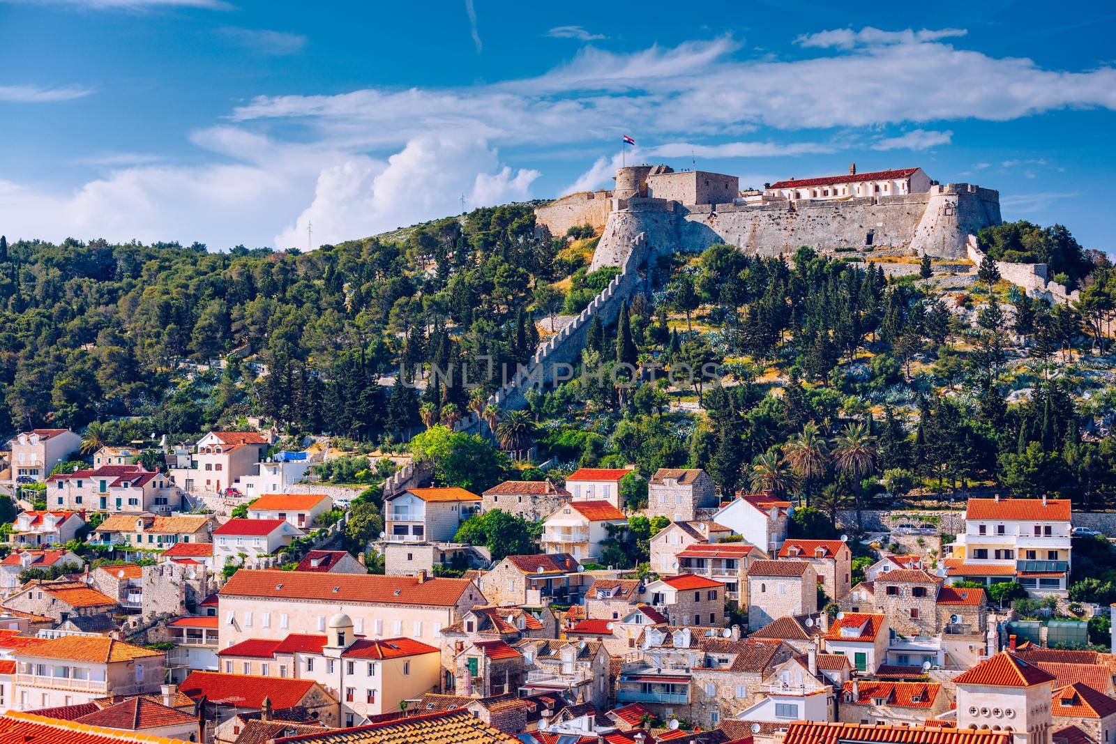 Panoramic view of Hvar town with lots of red roofs in Croatia. Hvar houses and roofs mediteranean town. Beautiful stacked houses in Hvar off the Dalmatian coast in Croatia.