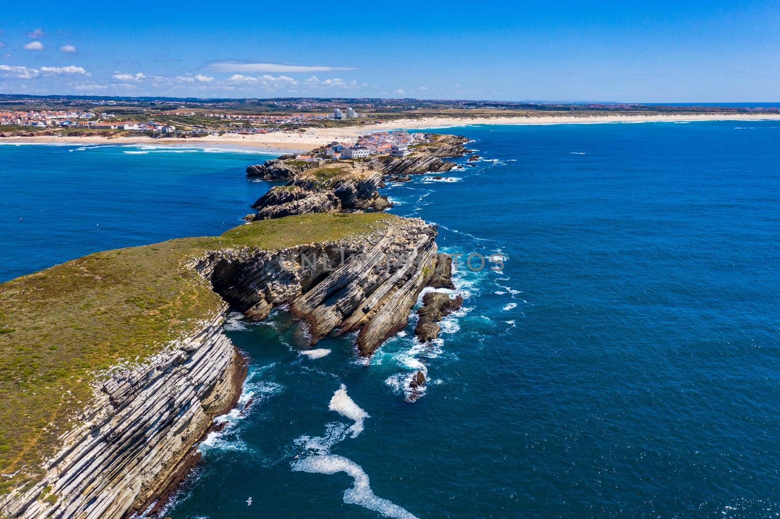 Aerial view of island Baleal naer Peniche on the shore of the ocean in west coast of Portugal. Baleal Portugal with incredible beach and surfers. Aerial view of Baleal, Portugal.