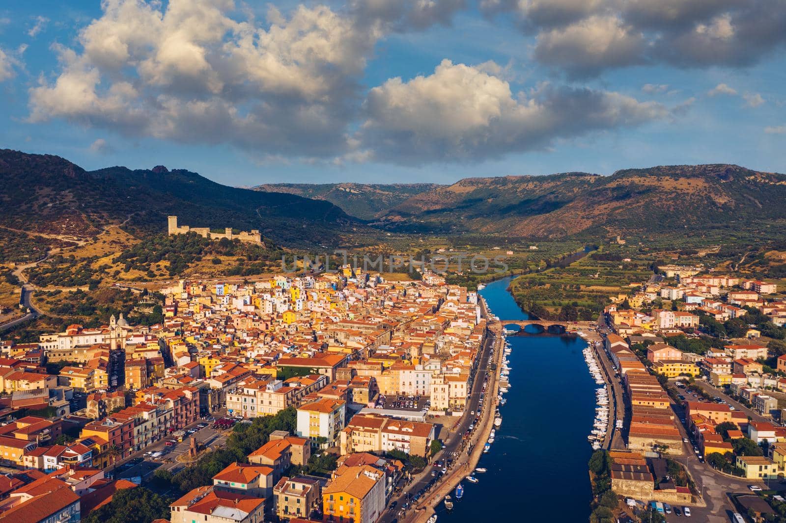 Aerial view of the beautiful village of Bosa with colored houses and a medieval castle. Bosa is located in the north-wesh of Sardinia, Italy. Aerial view of colorful houses in Bosa village, Sardegna.
