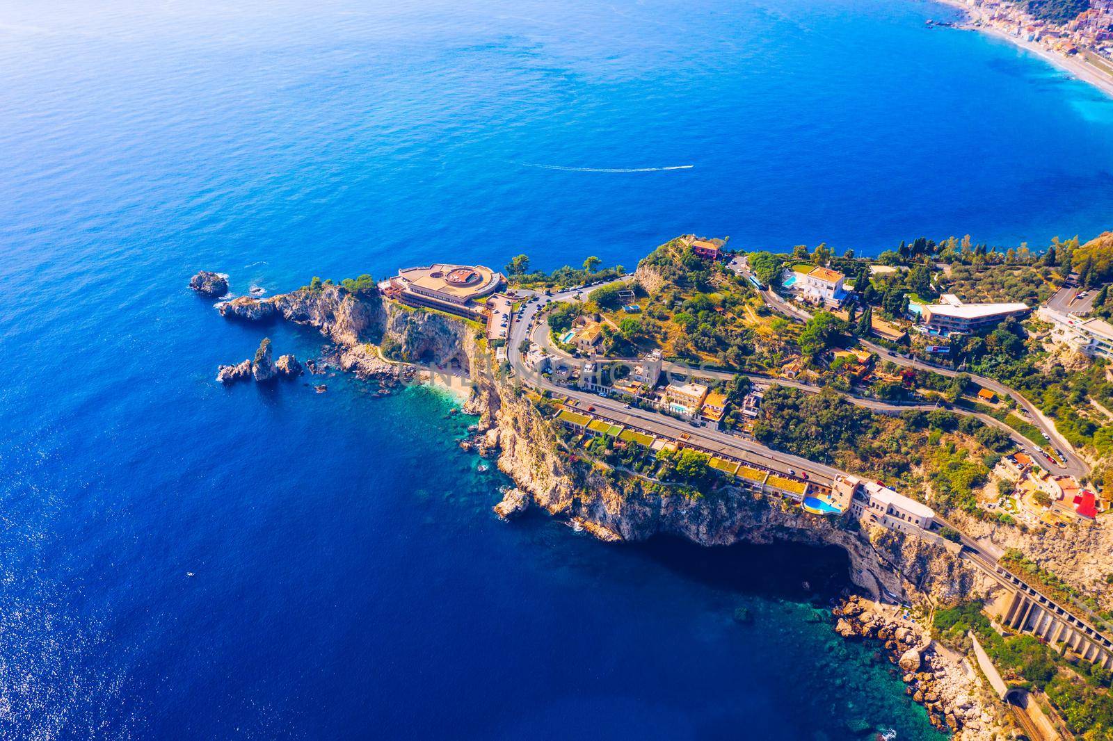 Taormina is a city on the island of Sicily, Italy. Mount Etna over Taormina cityscape, Messina, Sicily. View of Taormina located in Metropolitan City of Messina, on east coast of Sicily island, Italy.