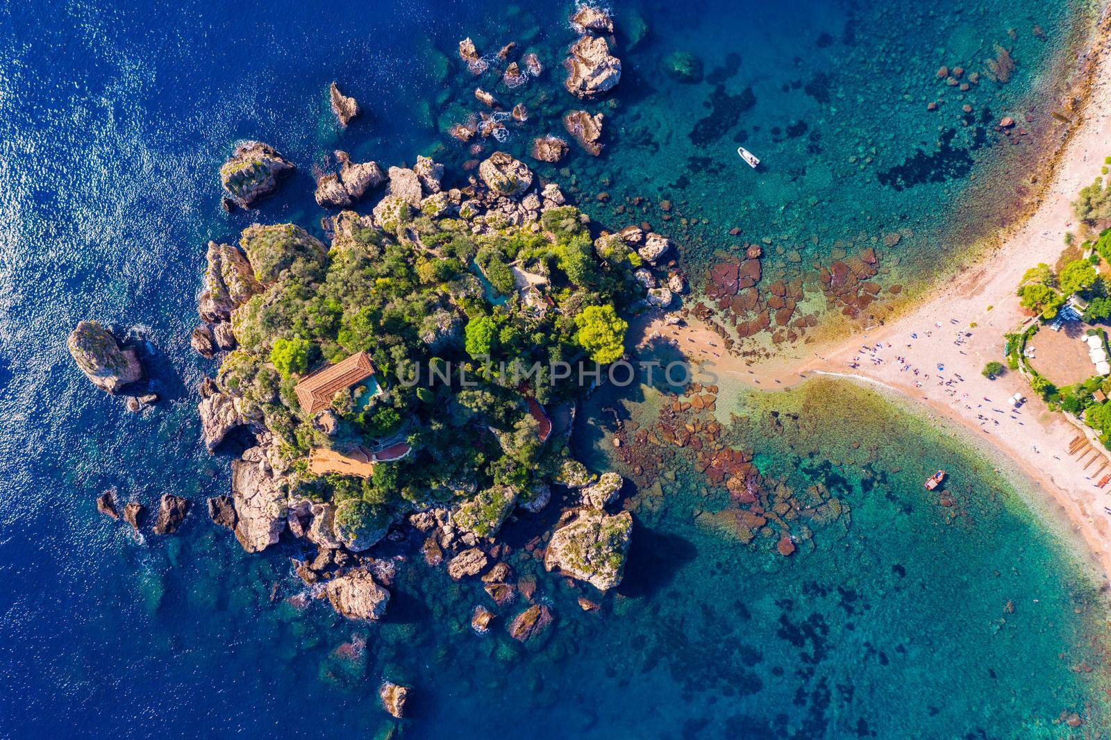 Aerial view of Isola Bella in Taormina, Sicily, Italy. Isola Bella is small island near Taormina, Sicily, Italy. Narrow path connects island to mainland Taormina beach in azure waters of Ionian Sea. 