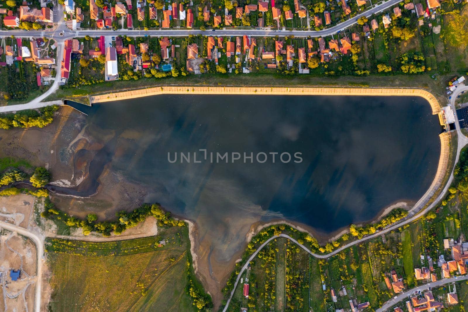 Beautiful Tismana lake and surrounding forest aerial panorama. Tismana, Romania.