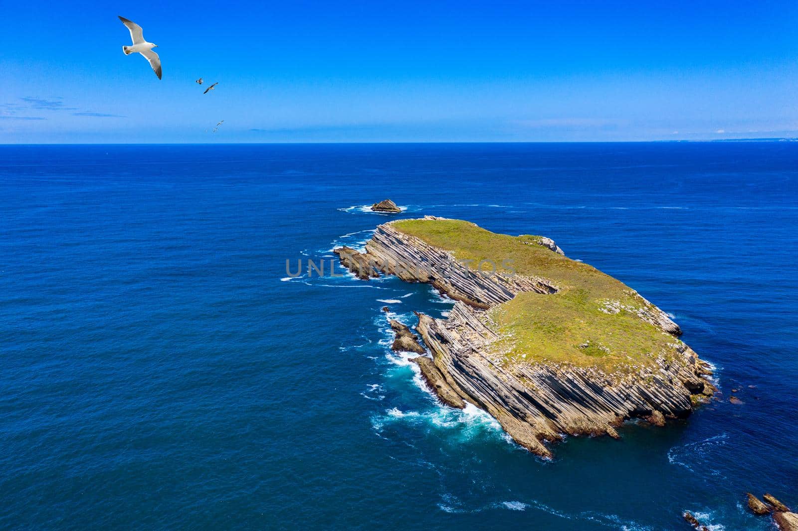 Aerial view of island Baleal naer Peniche on the shore of the ocean in west coast of Portugal. Baleal Portugal with incredible beach and surfers. Aerial view of Baleal, Portugal.