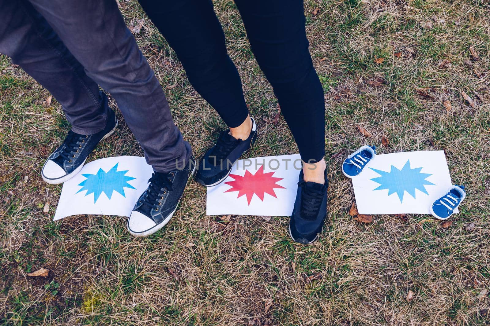 Young couple waiting for baby. Expecting parents with little baby boy shoes. Concept of Parents-To-Be. Shoes and sneakers of parents and expected baby. Mom, dad and the future baby Shoes.