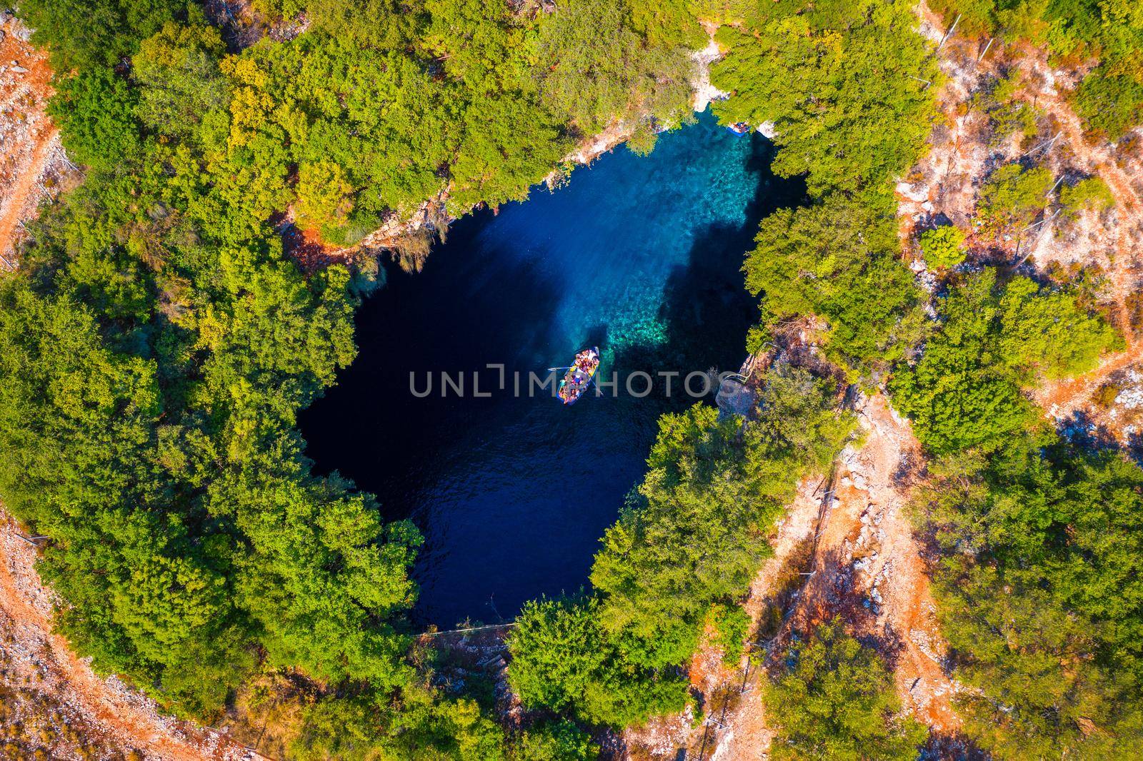 Melissani lake on Kefalonia island, Greece. Melissani Cave (Melissani Lake) near Sami village in Kefalonia island, Greece. Tourist boat on the lake in Melissani Cave, Kefalonia Island, Greece