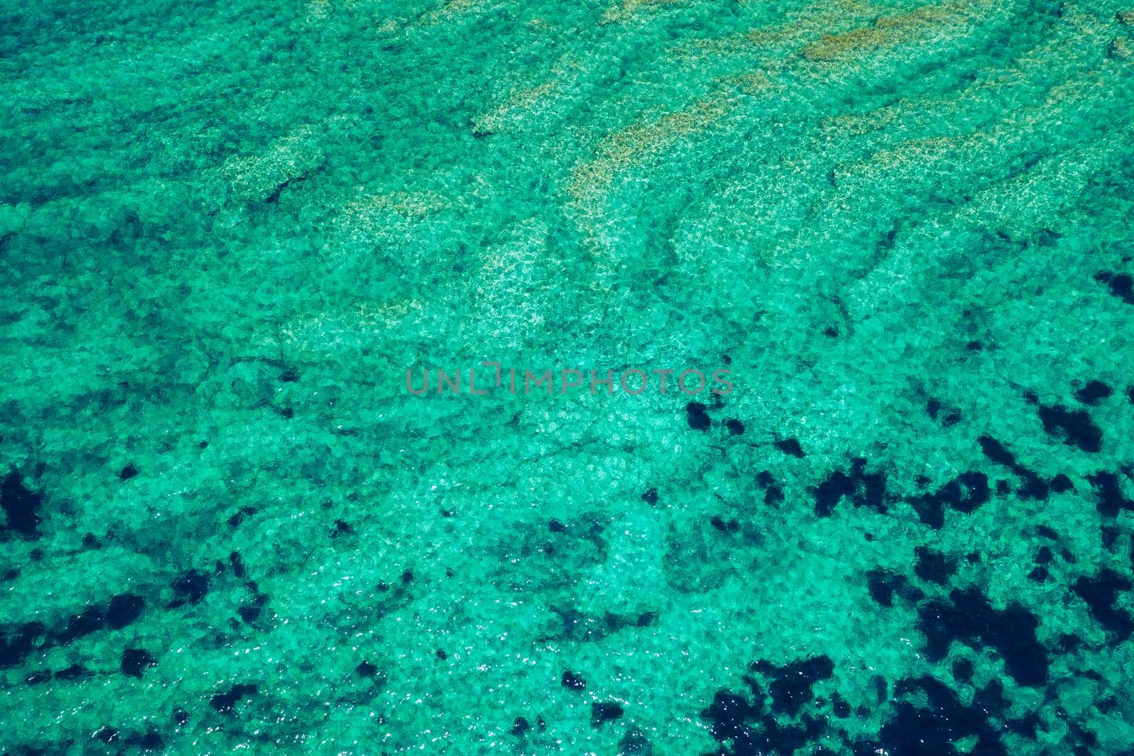 Sea surface aerial view. Background image of the turquoise sea. Deep sea and corals. Aerial drone shot of turquoise water, space for text. Aquamarine background. Sea Aerial view.