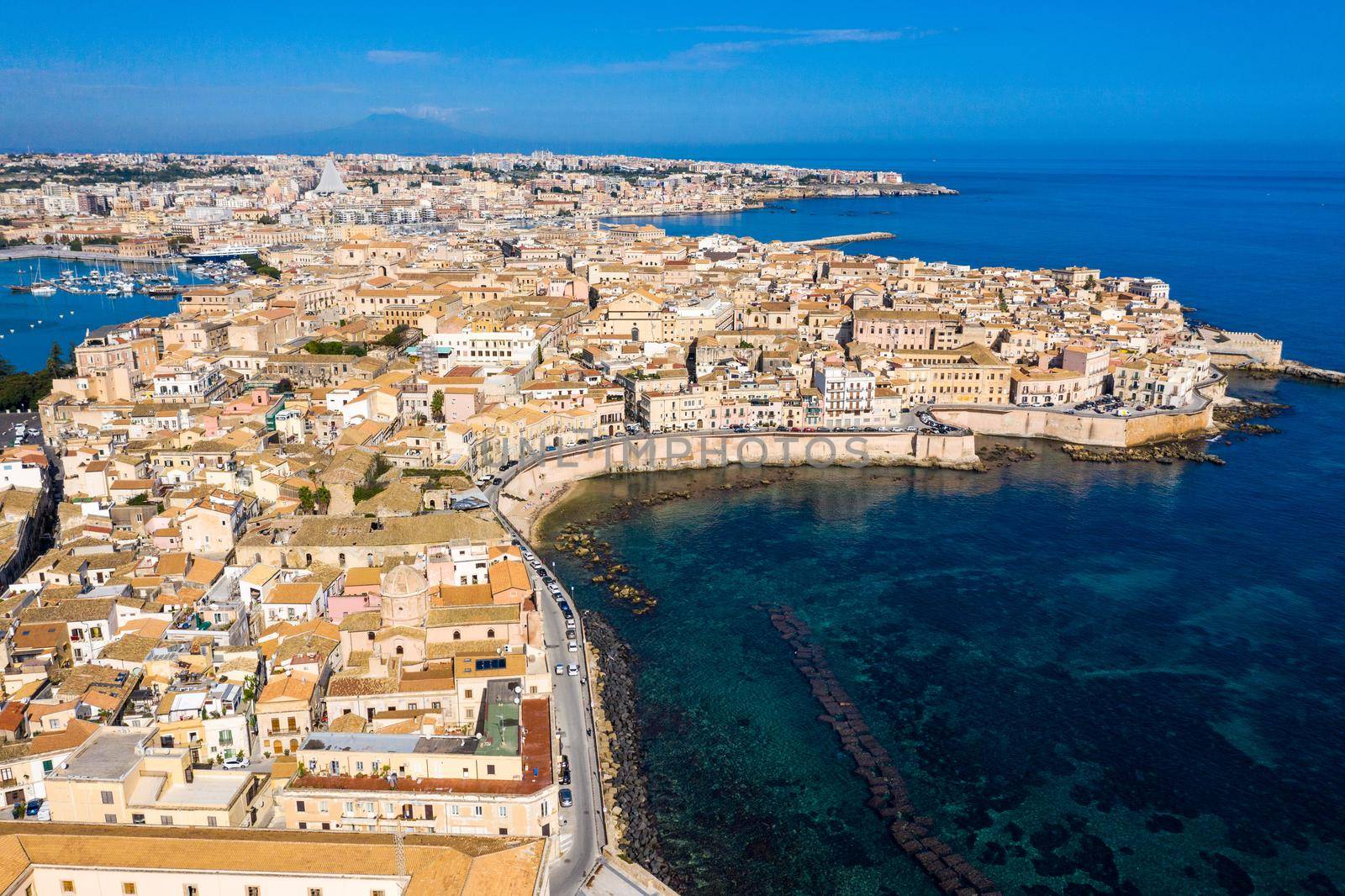 Siracusa, Ortigia Island from the air, Sicily, Italy. Isola di Ortigia, coast of Ortigia island at city of Syracuse, Sicily, Italy. Coastline town Syracuse, Sicily and old Ortigia island. Aerial view.