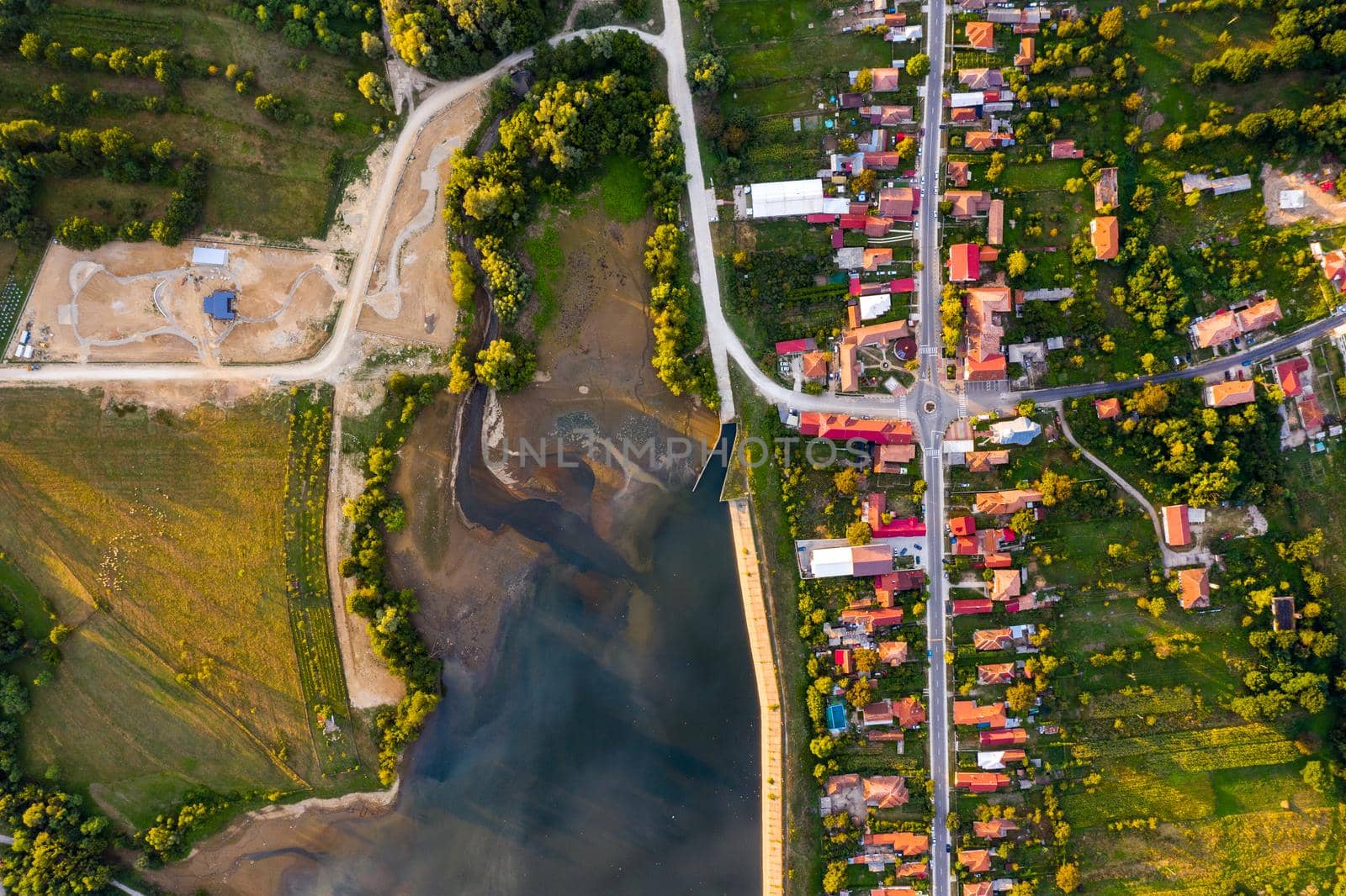 Beautiful Tismana lake and surrounding forest aerial panorama. Tismana, Romania.
